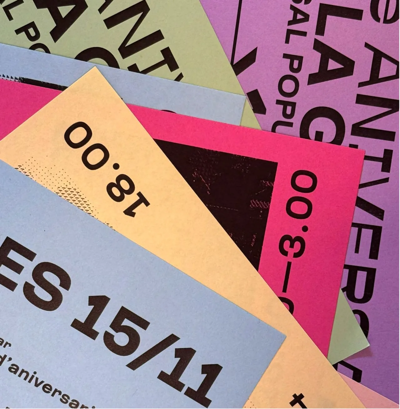 Detail of overlapping pastel posters with large single-ink typography