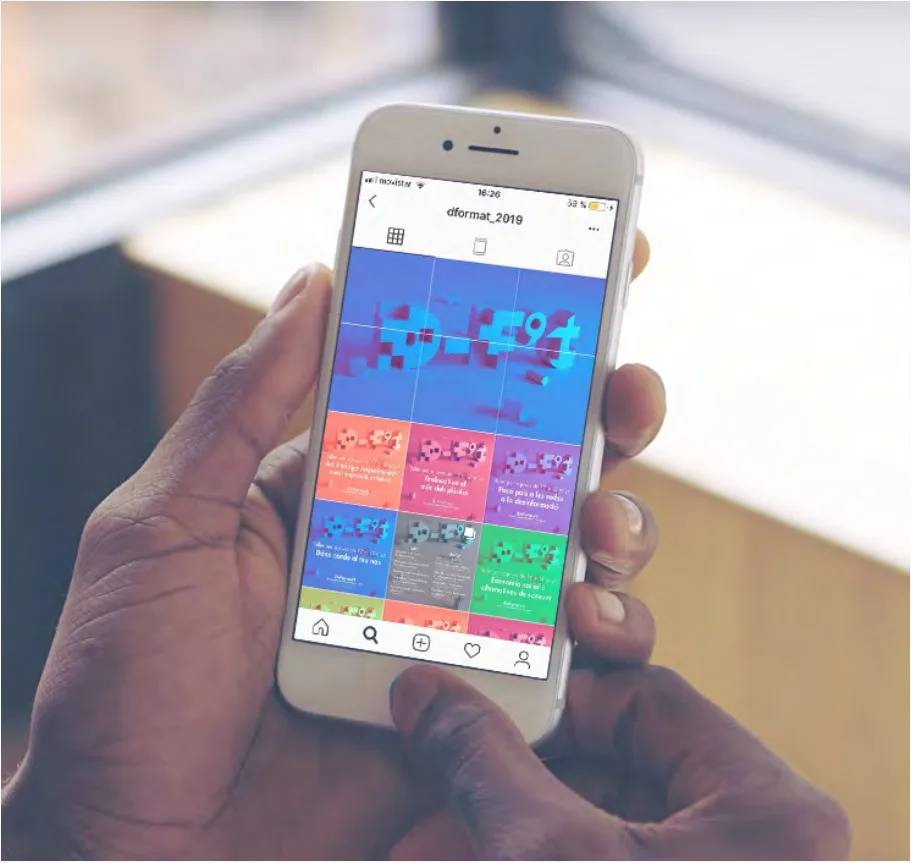 Hand holding a phone showing the D-Forma't Instagram profile