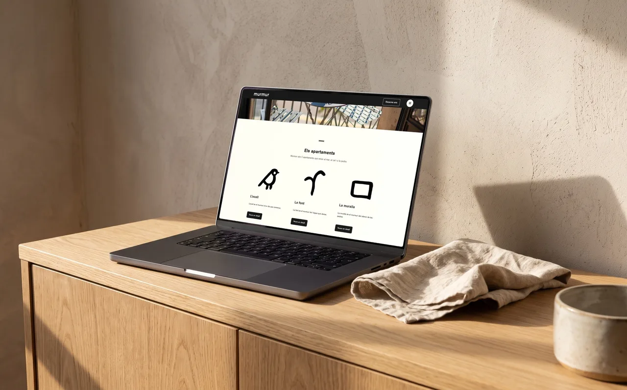 Laptop on a wooden cabinet showing the apartments section of the Murmur website